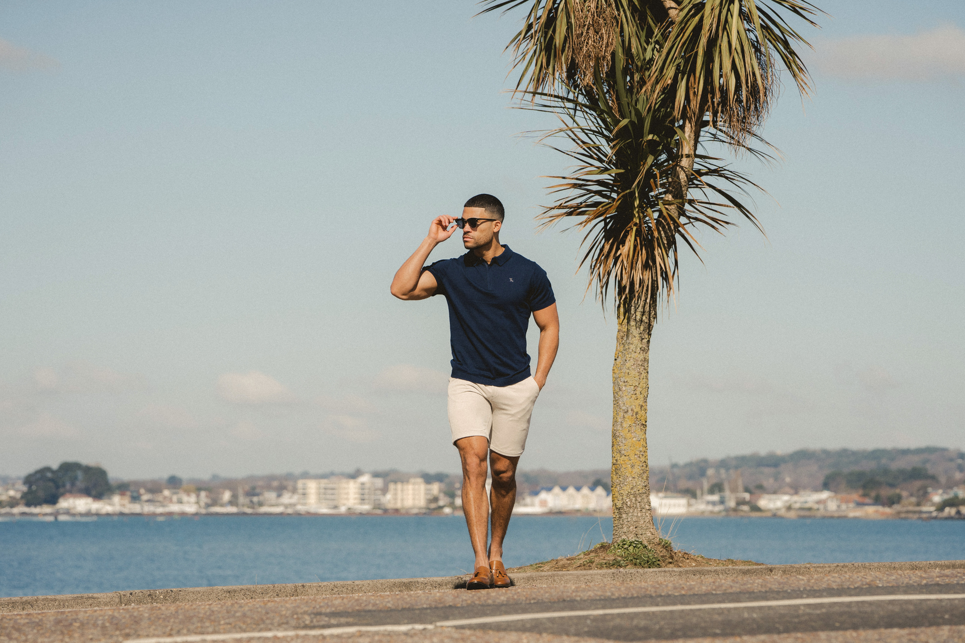 Beach side outfit. Man in Navy Polo paired with 365 shorts in Sand. True Muscle Fit Clothing. How I designed the perfect shorts.