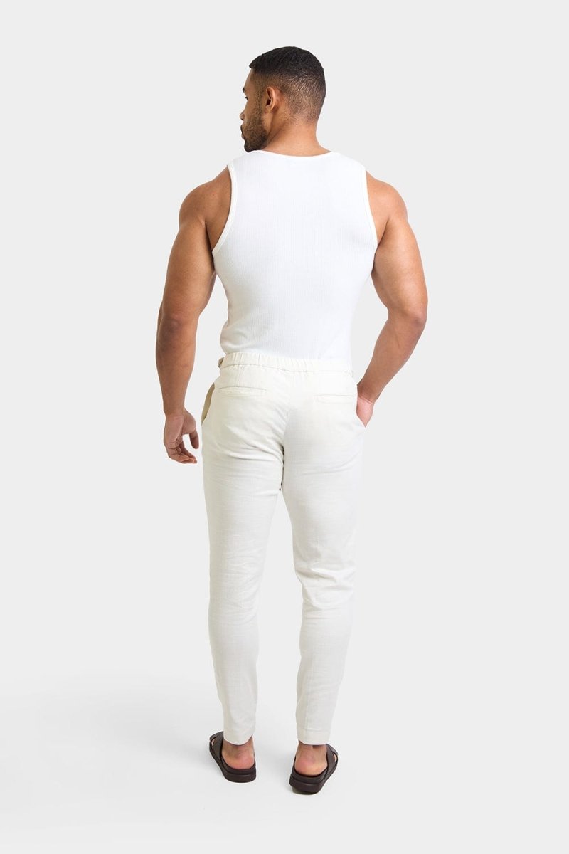 Linen Blend Cropped Pleated Trousers in Chalk - TAILORED ATHLETE - ROW